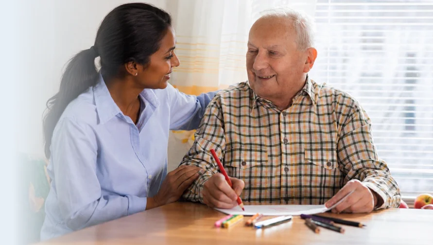 Occupational therapist working on hand coordination with an older man.