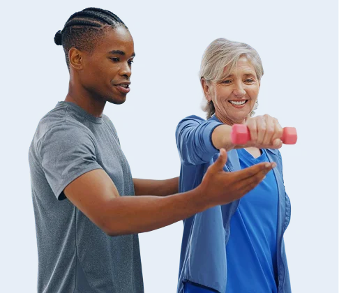 Caregiver assisting a senior woman with light exercise