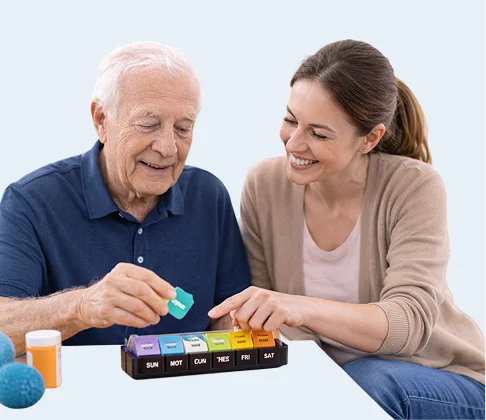 Caregiver helping a senior man organize daily medication