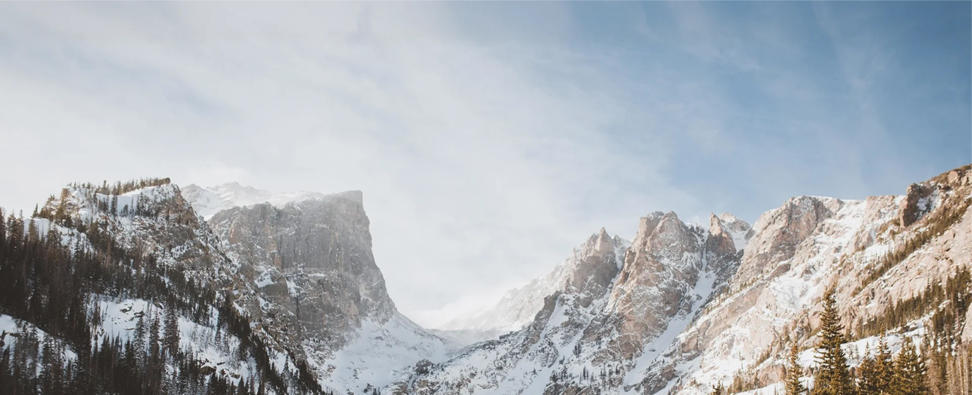 Snow-covered mountain peaks under a clear sky