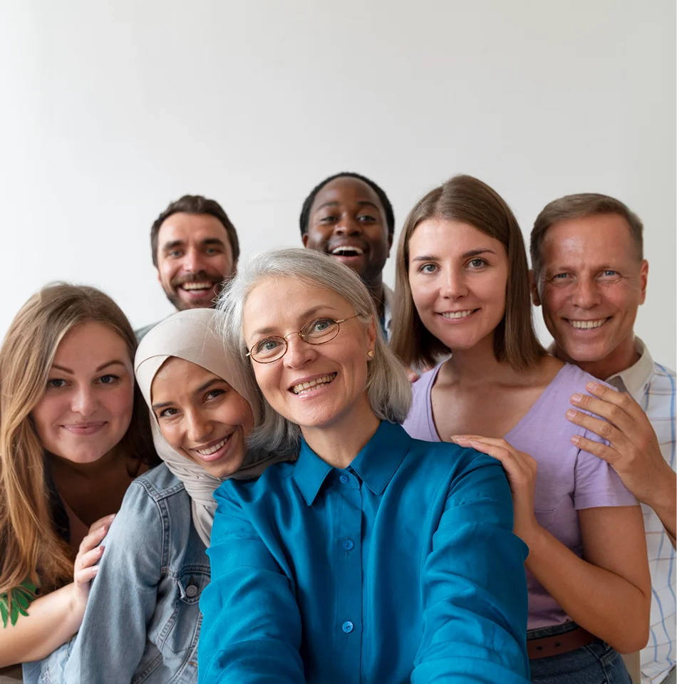 Diverse group of smiling caregivers taking a team selfie