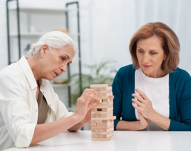 Senior women playing a wooden block game during cognitive therapy