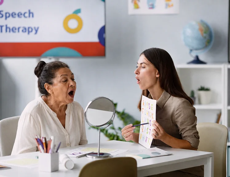 Speech therapist conducting a speech therapy session with a senior woman